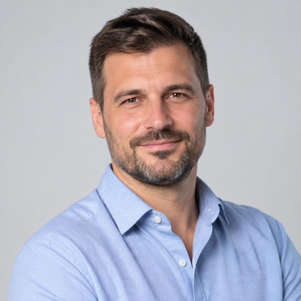 Croatian man in his 40s with short beard wearing a smart casual shirt, studio portrait